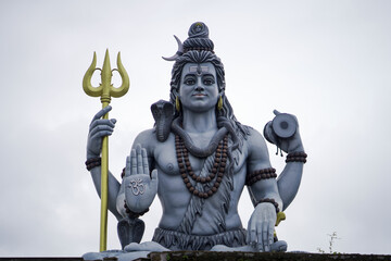 lord shiva majestic statue, shiva trident and damru idol, spiritual statue of shankar bhagwan, powerful hindu god sculpture, lord shiva with snake and rudraksha stock photo.







