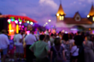 Blurred background. A city festival with people. Evening concert. A festive event. Crowd.