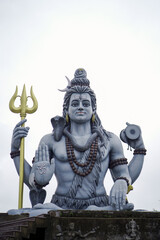 lord shiva majestic statue, shiva trident and damru idol, spiritual statue of shankar bhagwan, powerful hindu god sculpture, lord shiva with snake and rudraksha stock photo.







