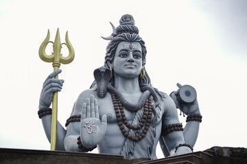 lord shiva majestic statue, shiva trident and damru idol, spiritual statue of shankar bhagwan, powerful hindu god sculpture, lord shiva with snake and rudraksha stock photo.








