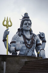 lord shiva majestic statue, shiva trident and damru idol, spiritual statue of shankar bhagwan, powerful hindu god sculpture, lord shiva with snake and rudraksha stock photo.







