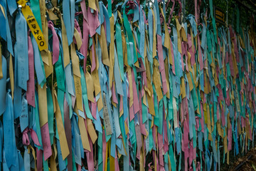 Prayer ribbons tied to a chain link fence, symbolizing hope for reunification between North and South Korea, inside a tourist area of the Korean DMZ in Paju, Gyeonggi-do, South Korea