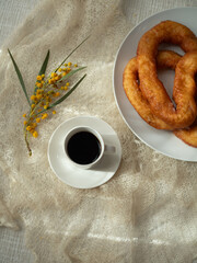 Plate of Frisjoli – Traditional Sardinian Carnival Fritters with Coffee, Mimosa, and Cashmere...