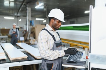 Furniture maker operating cnc machine in factory