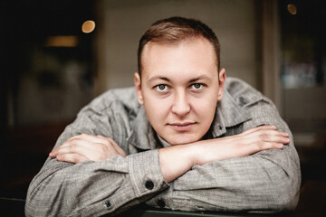 Man resting head on arms with calm expression