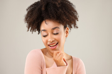 Portrait of beautiful Brazilian woman on gray background