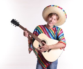 Smiling man in sombrero hat and colorful poncho playing guitar on white background