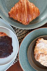 Butter plain and almond croissants served with Pain au Chocolat, yeasted puff pastry dough wrapped around a stick of chocolate