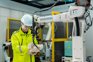 Robotic automatic technician man holding remote checking plan system of automation machine....