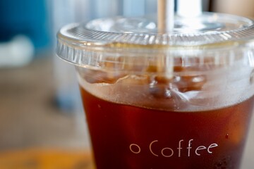 テイクアウトのアイスコーヒーとカフェの雰囲気