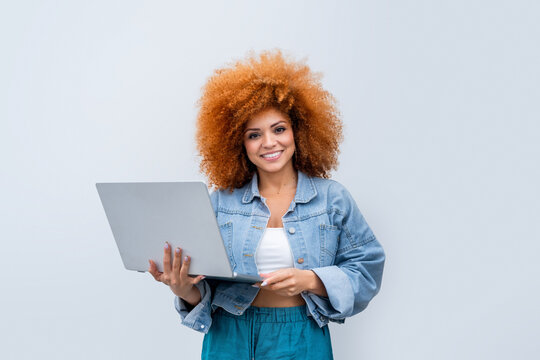 Young woman it specialist using laptop pc app for online business work, study isolated on white background. African American girl student holding computer studying, working. Looking at camera portrait