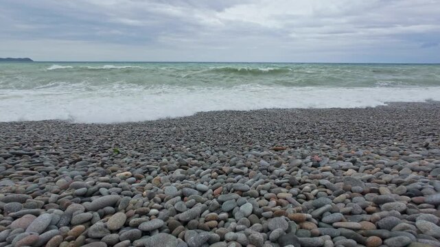 Low angle view of waves breaking along Looc Pebble Beach in Surigao Philippines.