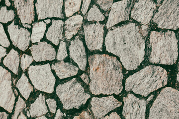 Obraz premium A wall made of stone with a rough texture