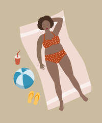 Woman lying on the beach sunbathing.