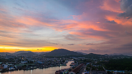 Aerial view of A amazing panoramic view of colorful sky over a large fishing port in Phuket. This port is important as a center for large fishing boats. A stunning sunset sky reflected on the water