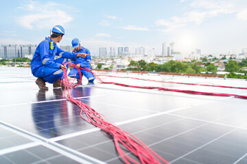 Electrical engineer inspecting and installing a solar panels on the building rooftop.