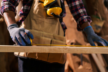 Professional African male carpenter is working professionally in sawmill - workshop.