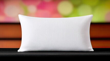White Rectangular Pillow on Black Surface Against Blurred Background