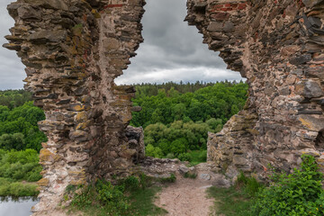 Ruins of tower medieval Hubkiv Castle on steep riverbank, Ukraine