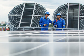 System engineer inspects an air ventilator system building rooftop.