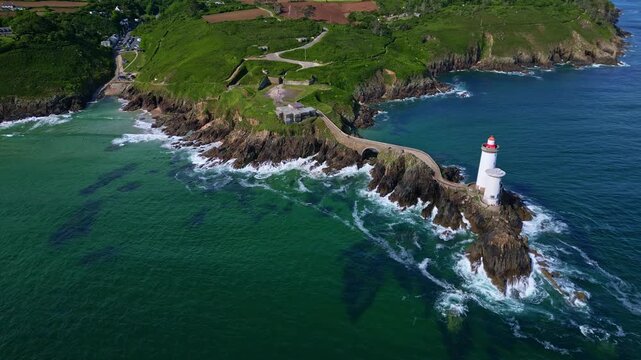 High altitude drone movement towards the coastal peninsula with dazzling Petit Minou lighthouse, Plouzan&eacute;, Finist&egrave;re, Brittany, France.
