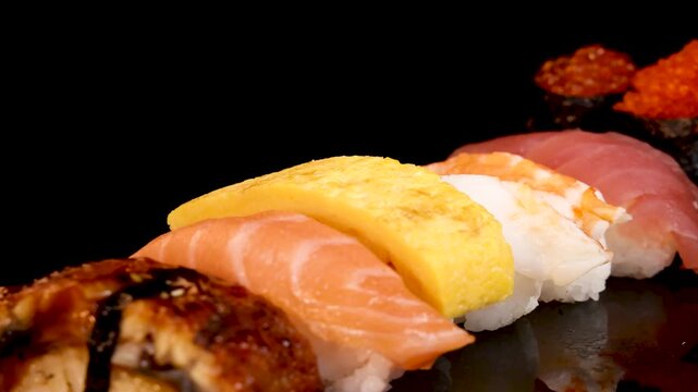 Rotating Assorted Sushi and Sashimi Set on Black Background