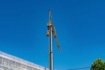 Construction crane towering against blue sky