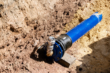 Blue pipe installation for water system in urban area.