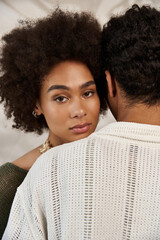 Young couple shares a moment of love and connection in a stylish, cozy setting