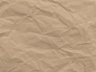 Crumpled kraft old brown paper texture background with copy space for design. Crumpled old brown vintage paper surface texture for background.