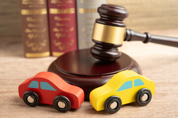 Hammer gavel judge with car vehicle accident, insurance coverage claim lawsuit court case.