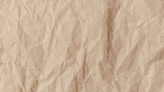 Crumpled kraft old brown paper texture background with copy space for design. Crumpled old brown vintage paper surface texture for background.