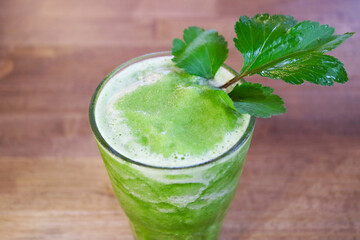 Mouthwatering Homemade Vegetable Juice with White Mugwort on Wooden Table