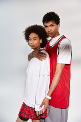 Stylish young couple expressing love in a modern setting with confidence and charisma