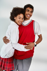 Young couple radiating love and style in a cozy urban setting during a sunny afternoon