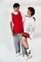 Young couple sharing laughter and warmth in stylish urban outfits