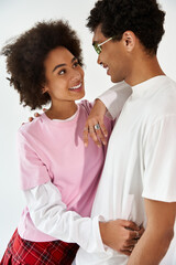 Young couple sharing a joyful moment filled with love and style in a bright space