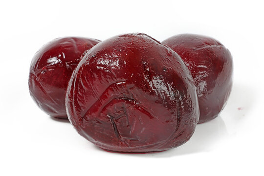 Whole cooked beetroot on a white background.