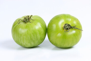 Heirloom Green Zebra tomatoes on a white background