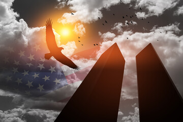 Silhouette of Towers with soaring eagle and flying birds on background of black and white sky and...