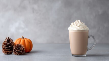 Velvety pumpkin latte crowned with whipped splendor, nestled among autumnal pinecones; celebrate Mabon and cozy Hygge moments
