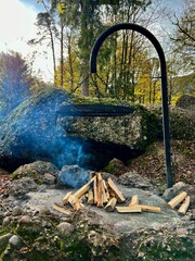 Rustic Outdoor Fireplace in Forest Setting
