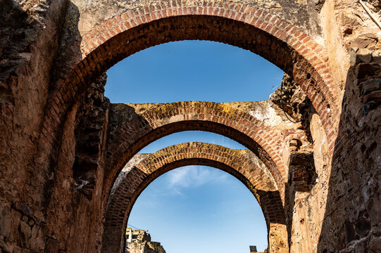 Historic Roman stone corridor with multiple brick arches, Merida, Spain - Powered by Adobe