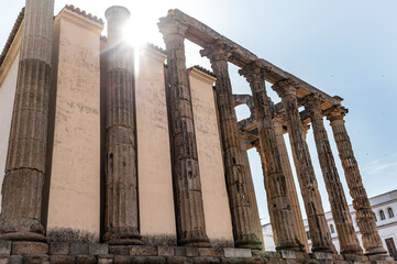 Ancient Roman Temple of Diana with sun flare behind enduring stone pillars