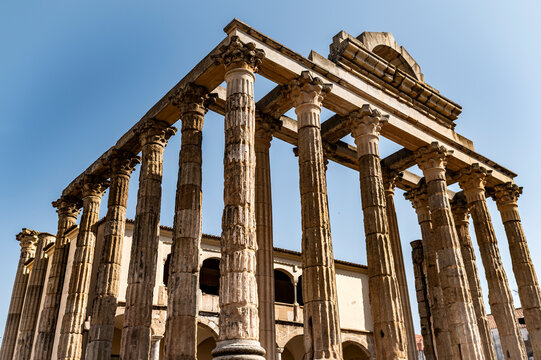 Imposing Roman temple columns under clear blue sky