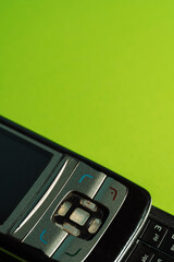 Detailed macro shot of old mobile phone interface against a lime green backdrop. High quality photo