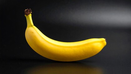 Single ripe banana on black background