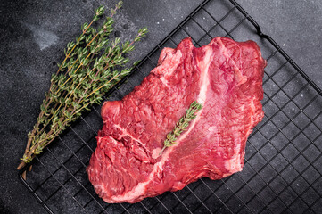Raw hanging tender or onglet beef steak. black background. top view
