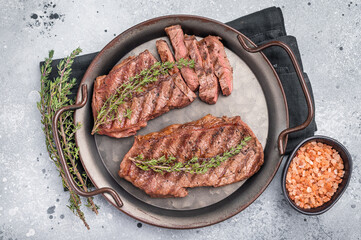 Roast Top blade steak, grilled beef shoulder meat. grey background. top view