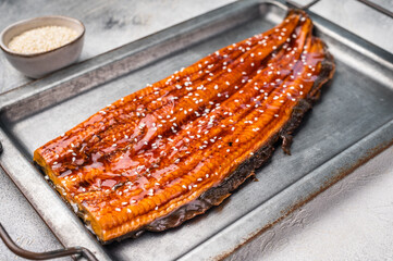Unagi eel, grilled fish fillet with sauce. grey background. top view